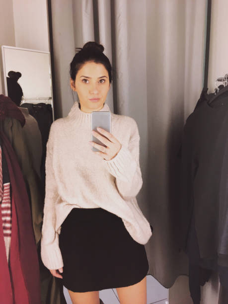istock Young woman in a fitting room 877068598