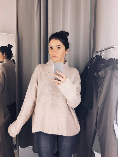 istock Young woman in a fitting room 877068694