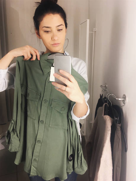 istock Photographing in a fitting room while trying clothes 877069338