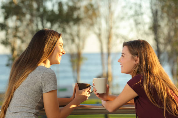 istock Two happy friends talking outdoors in a balcony 877069480