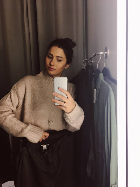 istock Photographing in a fitting room while trying clothes 877069502