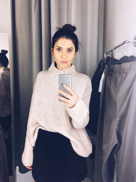 istock Photographing in a fitting room while trying clothes 877069522