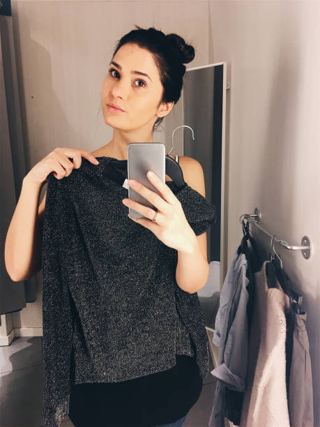 istock Photographing in a fitting room while trying clothes 877069538