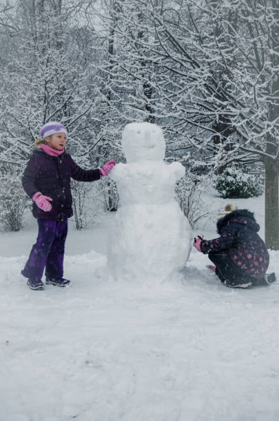 istock children enjoying winter atmosphere in the park 877071990