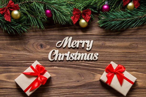 istock Cute Merry Christmas theme with two luxurious gift boxes on the wooden background 877073256