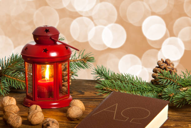 istock Still life with red lanter, walnuts and bible. 877076482