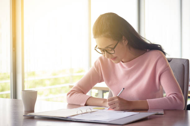 istock young asian businesswoman working in startup office 877080076