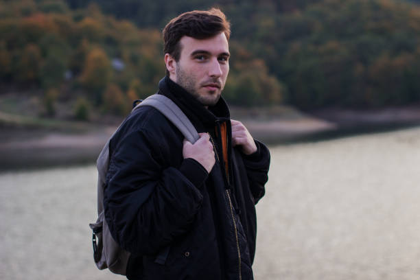 istock A man standing by the lake 877080482