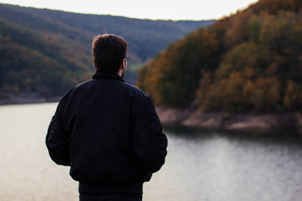 istock A man standing by the lake 877086758