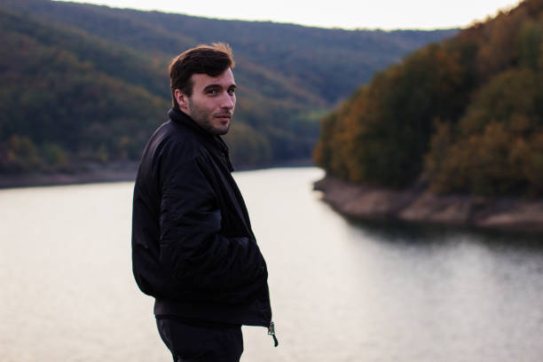 istock A man standing by the lake 877088236