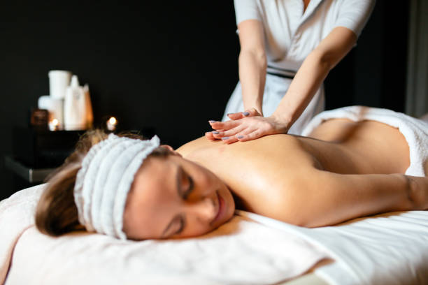 istock Massage therapist massaging woman 877091724