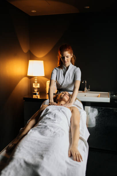 istock Massage therapist massaging woman 877092498
