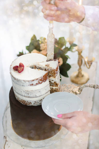 istock Hand with knife cutting christmas cake during celebration. 877101666