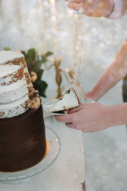 istock Hand with knife cutting christmas cake during celebration. 877101860