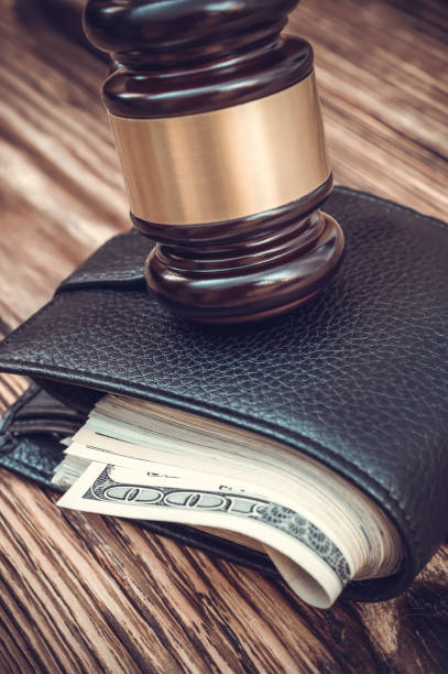 istock Gavel and wallet with money on the table. Toned image. 877102576