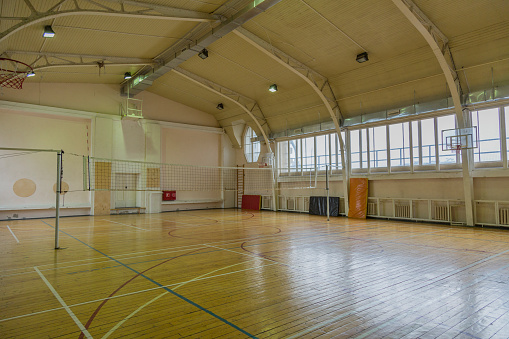 Vintage sports hall in old school with a volleyball mesh