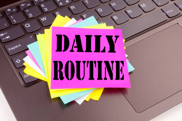 istock Writing Daily Routine text made in the office close-up on laptop computer keyboard. Business concept for Accuracy Procedure Workshop on the black background with copy space 877105256