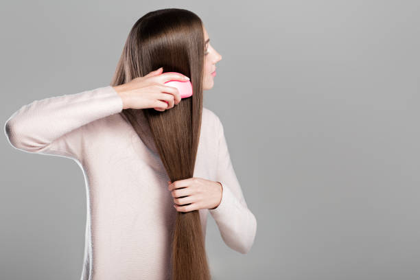 istock woman combing  long natural hair 877106032