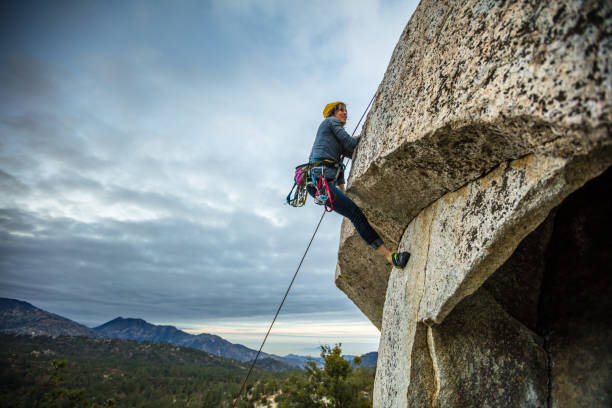istock Rock Climbing Woman Scrambling Over Overhang 877106160