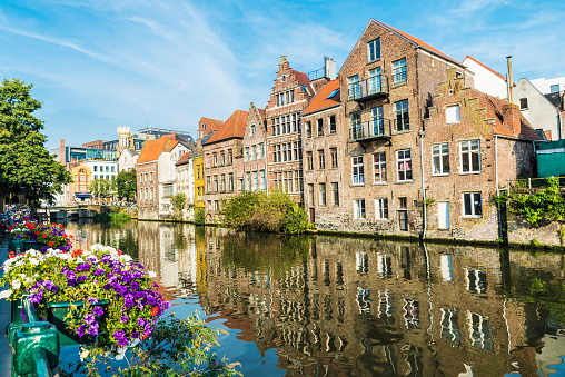 Flower pot along the Leie river with its typical houses in the medieval city of Ghent, Belgium