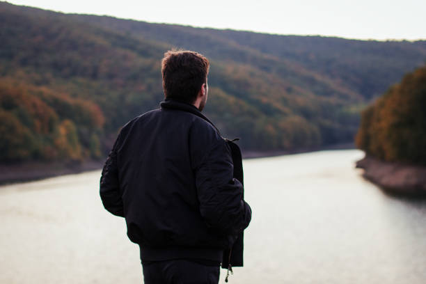 istock A man standing by the lake 877111288