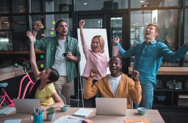 istock Joyful skilled colleagues are celebrating their triumph 877111396