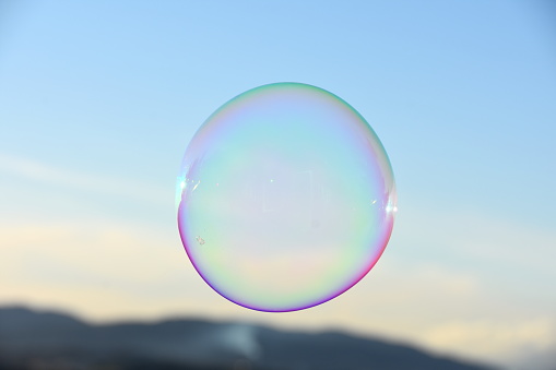 Soap bubble floating in the air and blue sky background