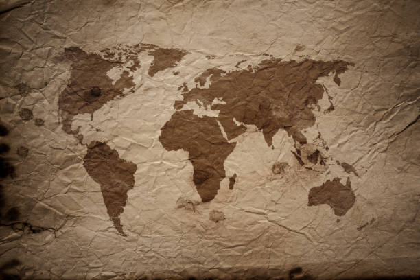 istock World Map on aged damaged paper 877111774