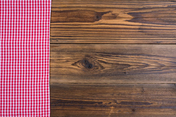 istock Rustic old wood background with red white checkered cloth with copy space in the right picture area 877115228