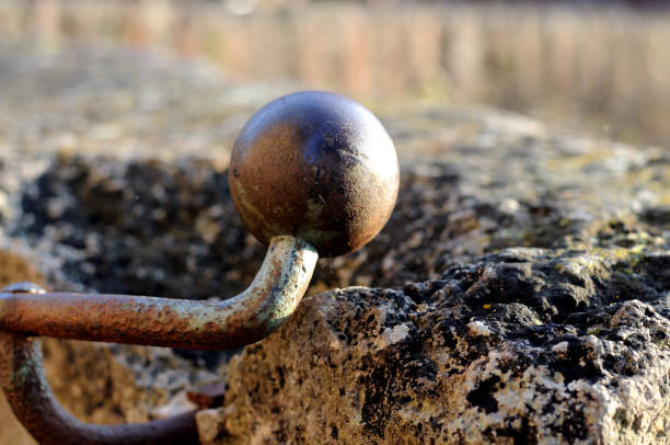 spherical shaped endpiece of an iron railing at a city wall