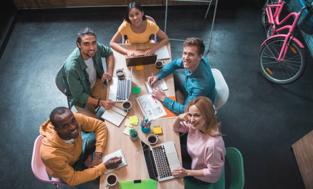 istock Happy business team working together in room 877118900
