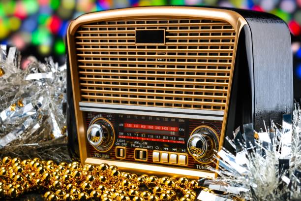 istock radio receiver in retro style with christmas decorations on bokeh lights background 877119576