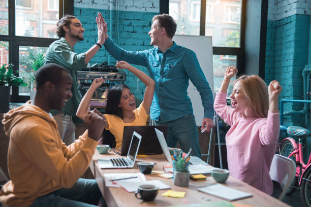 istock Happy colleagues raising up arms 877121434