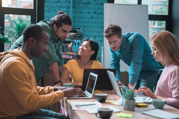 istock Happy comrades working with laptop 877121578