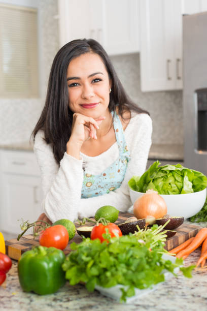 istock Young Hispanic Women Preparing a Meal 877125704