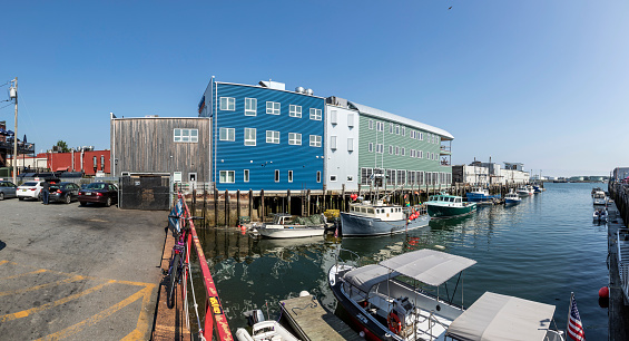 Portland: old wharf area in Portland with motorboats and old halls from fishing industry. Renovated for tourism.