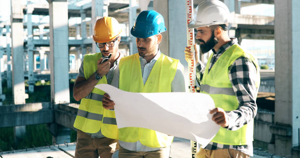 istock Portrait of construction engineers working on building site 877129430