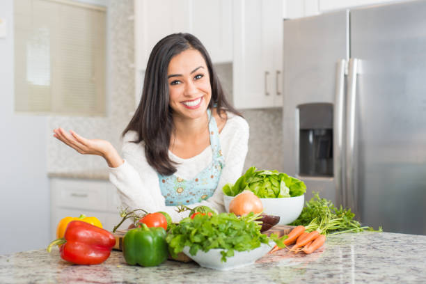 istock Young Hispanic Women Preparing a Meal 877129506
