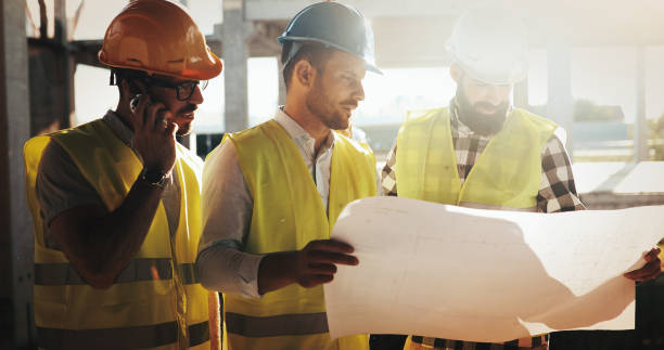 istock Portrait of construction engineers working on building site 877129540