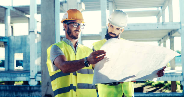 istock Team of architects people in group on construciton site 877132516