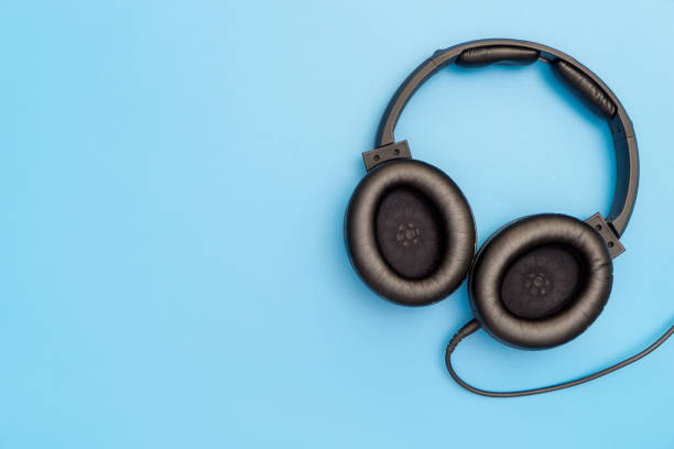istock Black Leather Headphone on blue copy space for Music Concept 877132538
