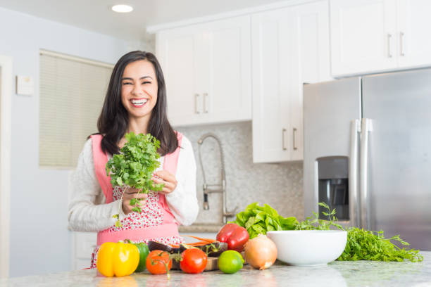 istock Young Hispanic Women Preparing a Meal 877132872