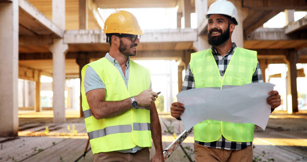 istock Team of construction engineers working on building site 877133118