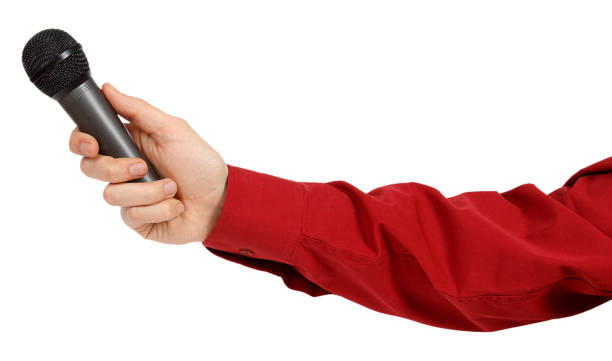 Man's hand in a red shirt holding a microphone