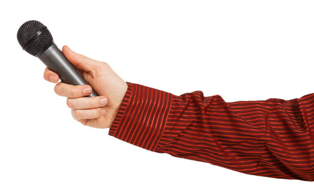 istock Man's hand in a red shirt holding a microphone 877133132