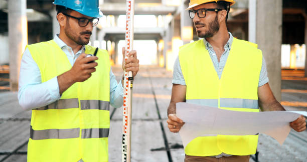 istock Team of architects people in group on construciton site 877136280