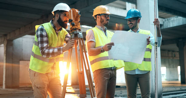 istock Team of architects people in group on construciton site 877136740