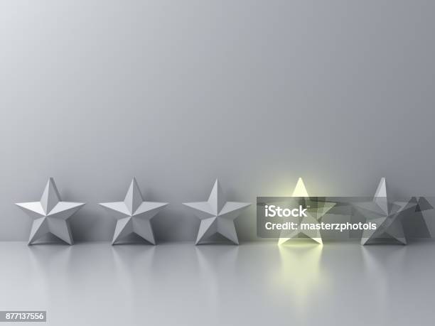 Stand Out From The Crowd And Different Creative Idea Concepts One Glowing Star Standing Among Other Dim Stars On Grey Background With Reflections And Shadows 3d Render Stock Photo - Download Image Now