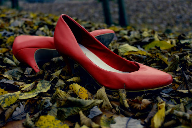 istock Deserted Red Shoes In Forest 877139958