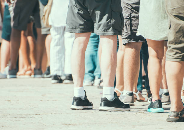 istock People standing in a queue on the street. 877144460
